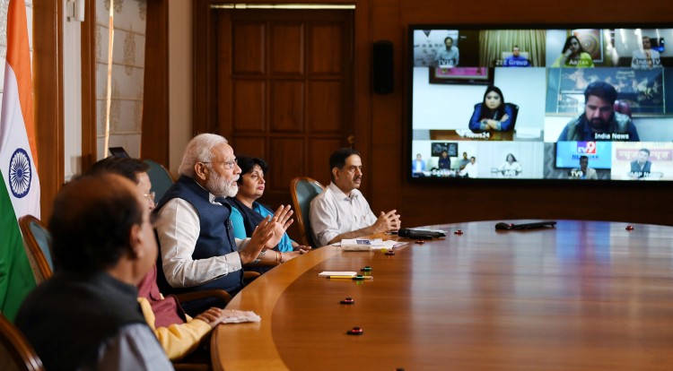 narendra modi interacting with the media through video conference