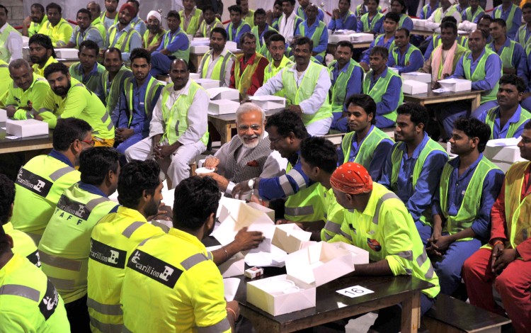 narendra modi sharing the meal with indian workers at workers