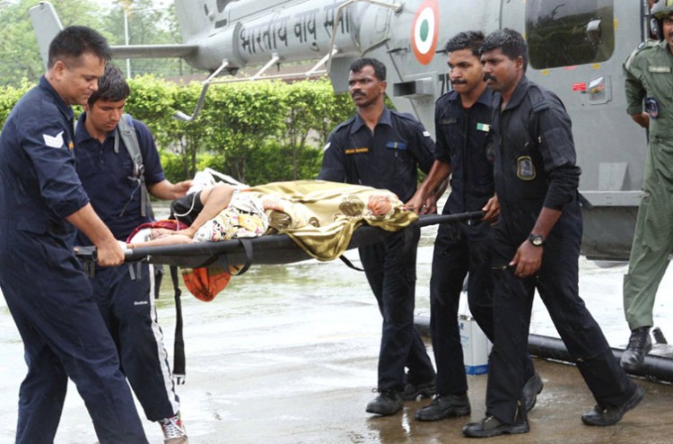 iaf personnel carry an injured pilgrim on s stretcher in dehradun, on their rescue work in flood-hit uttarakhand