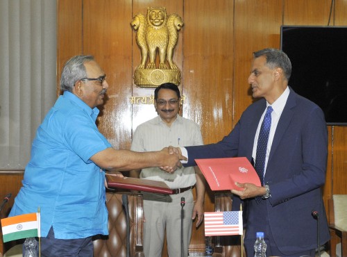 rajiv mehrishi and richard r. verma exchanging the documents